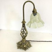 An Edwardian brass lamp, the moulded neck on twisted body with foliate base, with vaseline glass