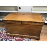 A 19thc pine kist, the interior with candle box, with drop handles to side, on plinth base (43cm x