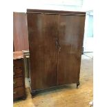 A 1930s/40s mahogany gentleman's wardrobe with fitted interior including drawers and mirrors, some