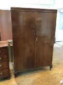 A 1930s/40s mahogany gentleman's wardrobe with fitted interior including drawers and mirrors, some