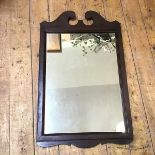 A wooden framed wall mirror, the rectangular plate in moulded frame with swan neck crest (75cm x