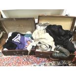 Two vintage travelling cases with an assortment of linens