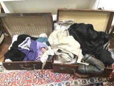 Two vintage travelling cases with an assortment of linens