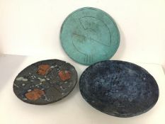 A copper plate with abstract design (d.29cm) and two Studio Pottery plates, one with chip to rim (