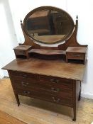 An Edwardian dressing table, the oval hinged mirror flanked by two jewellery drawers above an