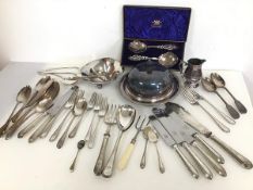 An assortment of Epns including a lidded serving dish, dinner forks and knives, spoons, fish