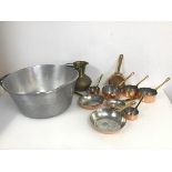 An assortment of small pans with copper bases and brass handles (largest: 3cm x 28.5cm x 14.5cm),