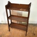 An Arts & Crafts oak open bookshelf fitted three shelves each with an open back and side, on
