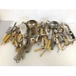 A large quantity of Epns cutlery including bone handled knives and forks, sugar nips, knife rests