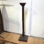 A large wooden Classical column stand, with stepped rectangular top above an Ionic capital, with