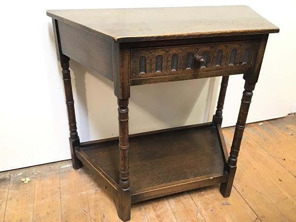 A 1920s oak Credence table fitted single frieze drawer over a lower tier, on turned supports
