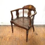 An Edwardian mahogany tub chair, the crest rail with Classically inspired inlay, with three vase