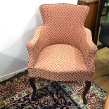 A 1920s upholstered easy chair in later fabric with a rope pattern, on cabriole front supports (84cm