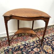 An unusual Edwardian mahogany side table, eliptical to one side and serpentine to the other, with