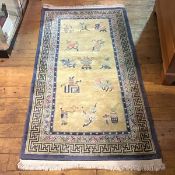 A Chinese washed wool rug, with vases, urns, paintbrushes and other symbols on gold field within