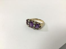 A 9ct gold ring set three amethysts with spacing rows of seed pearls (P) (6g)