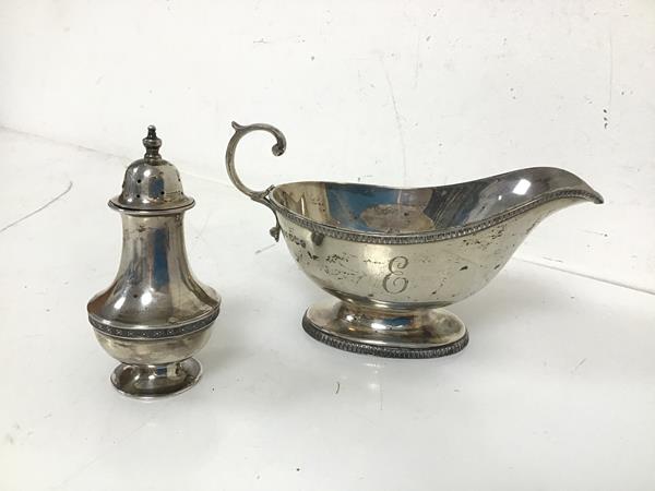 A Mappin & Webb Sheffield silver sauceboat with the initial E and a Mappin Webb Birmingham silver