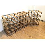 Two modern wood and metal wine racks, one with a twenty four bottle capacity, the other twelve (