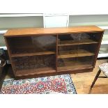 A 1960s/70s teak side cabinet, with sliding glass doors and adjustable shelves to interior, on