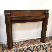 An Art Deco mahogany fire surround with fluted pilasters (121cm x 140cm x 23cm)