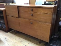An Avalon 1960s/70s teak sideboard with an arrangement of drawers and cupboards including a fall