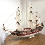 A wooden model of a 17thc. Warship, complete with stand (81cm x 104cm x 42cm)