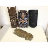 A collection of Tribal mask wall art (largest: 46cm x 18cm) (4)