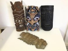 A collection of Tribal mask wall art (largest: 46cm x 18cm) (4)