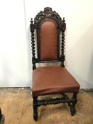 An oak Charles II style reproduction chair with foliate crest, padded back and seat, flanked by