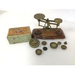 A set of early 20thc brass scales, complete with an assortment of weights and measures (scales: 11cm