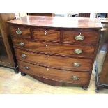 A Regency mahogany bow front chest with crossbanded top above three short drawers (central drawer