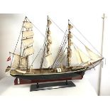 A model of a three masted tall ship on stand, stand bearing plaque, Georg Stage II, ship bearing