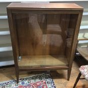 An oak and mahogany side cabinet, with two sliding glass doors and two adjustable shelves, on