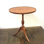 A reproduction wine table with mahogany crossbanded oval top with piecrust edge on moulded stem