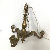 A brass three arm hanging light with foliate C scroll arms (41cm x 39cm)