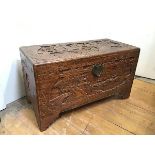 A Chinese camphorwood chest, carved with typical Chinese scenes to all sides, unfitted interior,