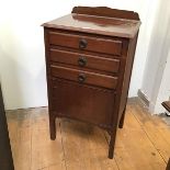 A 1930s/40s mahogany sheet music cabinet fitted three drawers above a single door, on straight