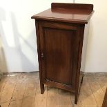 A 19thc mahogany bedside cabinet with gallery back, fitted single panel door with shelved