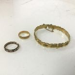 A mid 19thc Glasgow 18ct gold wedding band (2.53g), a rolled gold bangle with clasp and safety chain