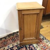 A Victorian pine bedside cabinet with panelled door, fitted single shelf to interior, on plinth base