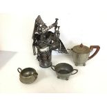 A novelty metal bottle holder designed as a bagpiper (35cm x 25cm x 20cm) and a pewter milk jug,