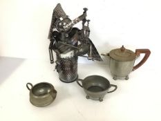 A novelty metal bottle holder designed as a bagpiper (35cm x 25cm x 20cm) and a pewter milk jug,