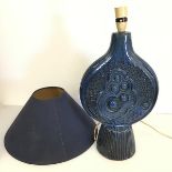 A 1970s style ceramic lamp, the flask shaped body on reeded base, complete with shade (47cm to top