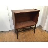 A mid century mahogany cabinet, lacking glass doors and shelves, on tapering square supports