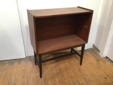 A mid century mahogany cabinet, lacking glass doors and shelves, on tapering square supports