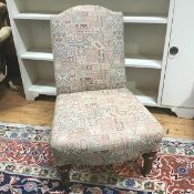 An Edwardian nursing chair in modern kelim style upholstery, on turned front supports terminating in