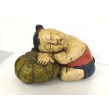 A Chinese carved wooden polychrome figure of a Young Child with Head Resting on Pumpkin (26cm x 37cm