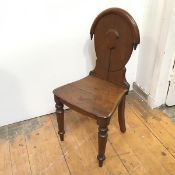 A mid 19thc hall chair with domed back above an oak seat, on turned front supports (88cm x 43cm x