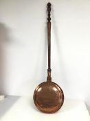 An early 20thc bedwarmer, with copper pan on turned oak handle (112cm)