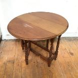 A late 19thc/early 20thc. mahogany gateleg occasional table, the oval top with moulded edge, on